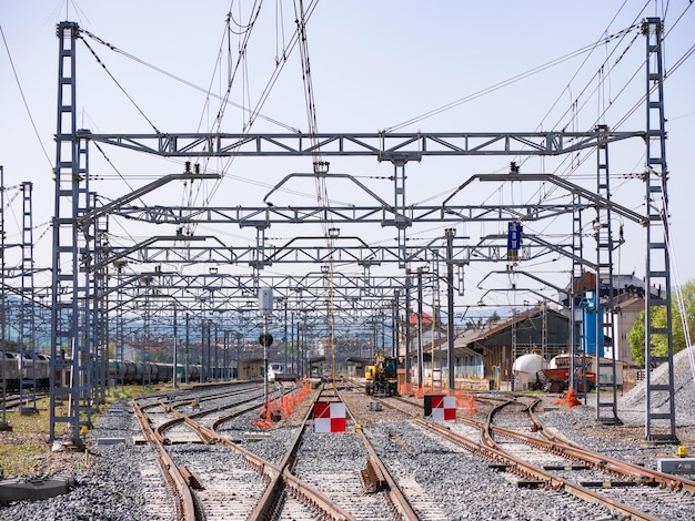 Train tracks under construction with red and white signs preventing traffic