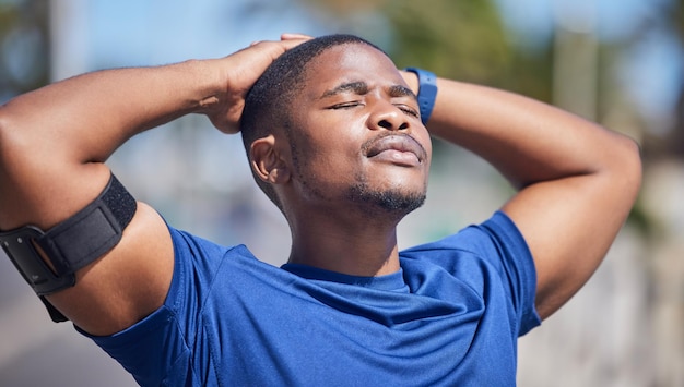 Training fitness and tired black man runner with sun on face for break from exercise cardio or running Workout stop and breathe by athletic male relax outside for marathon run or sport routine