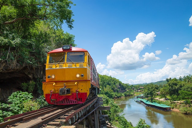 trains running on death railways track crossing kwai river in kanchanaburi thailand