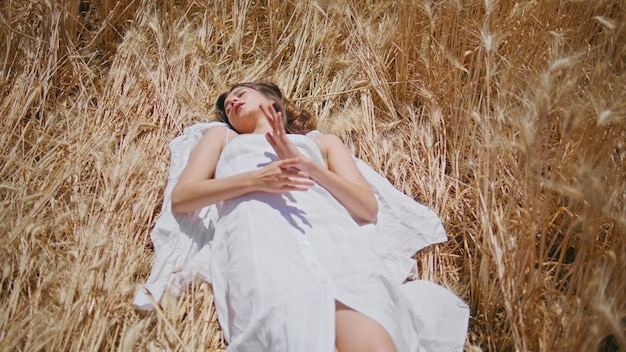 Tranquil lady resting sunlight spikelets nature rural woman laying rye field