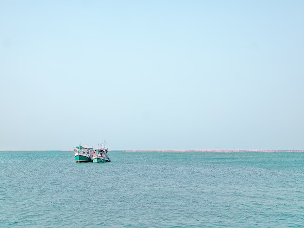 Tranquil Scenery of Two Fisherman Ships in the Sea with Horizon