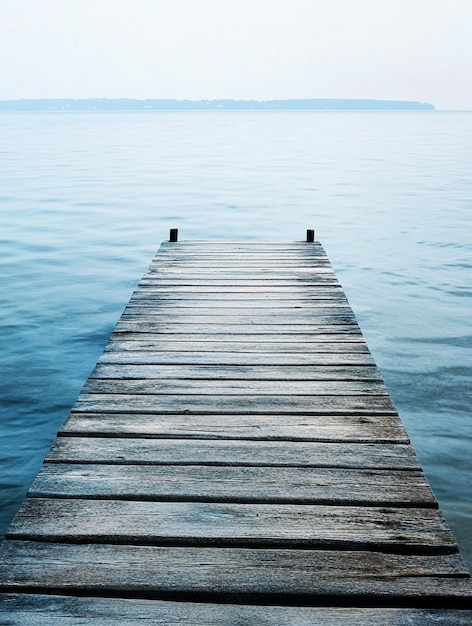 Tranquil Wooden Dock Over Serene Water at Dawn