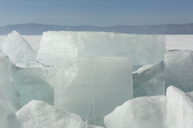 Transparent blue ice hummocks on lake baikal shore siberia winter landscape view snowcovered ice of