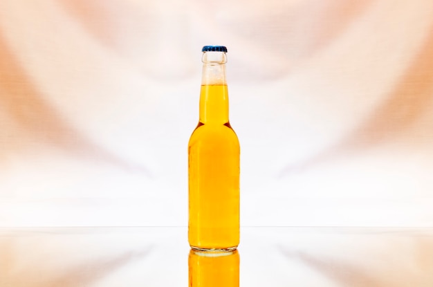 A transparent bottle of beer isolated on colorful