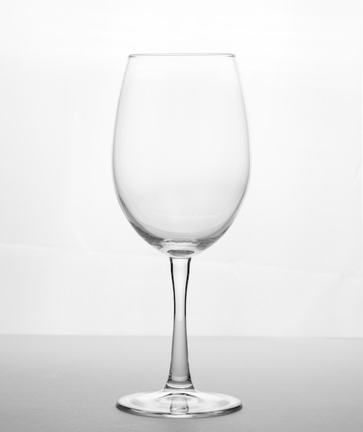 Transparent clear wine glass on a white.