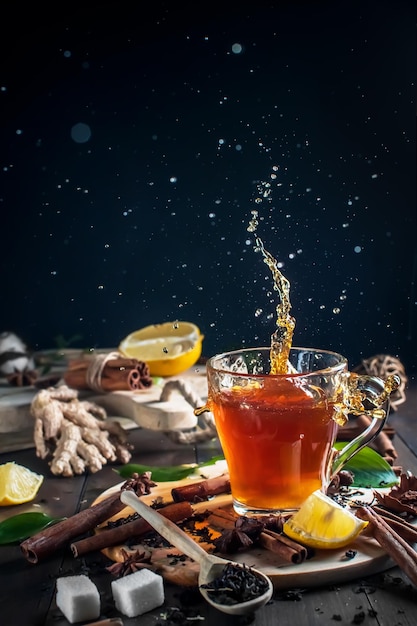 Transparent cup of tea with splash. ingredients for tea. beautiful tea background. soft focus