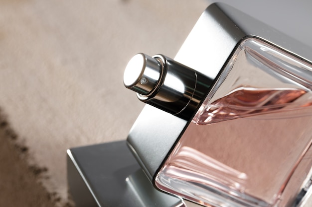 Transparent fragrance bottle on gray