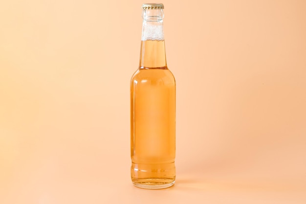 A transparent glass bottle of beer on a yellow background Fresh Traditional Light Refreshment Studio Label Trade Front Brand Label Transparent International Holiday