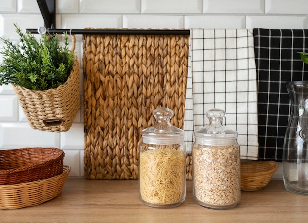 transparent glass jars with pasta and oatmeal on the kitchen table jar of vegetarian food