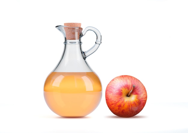 Transparent glass jug of organic apple cider vinegar isolated on white background