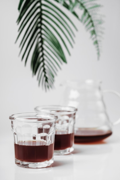 Transparent glass teapot and glasses on white background