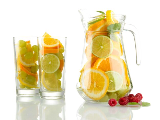 transparent jar and glasses with citrus fruits and raspberries isolated on white