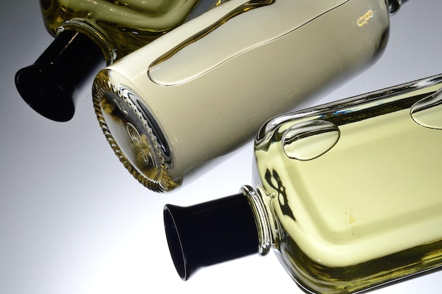 Transparent jars with perfume lie on a light background Closeup