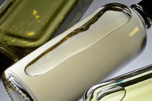 Transparent jars with perfume lie on a light background Closeup