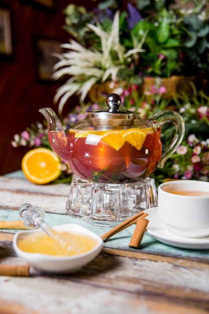 transparent kettle with fruit tea honey with cinnamon