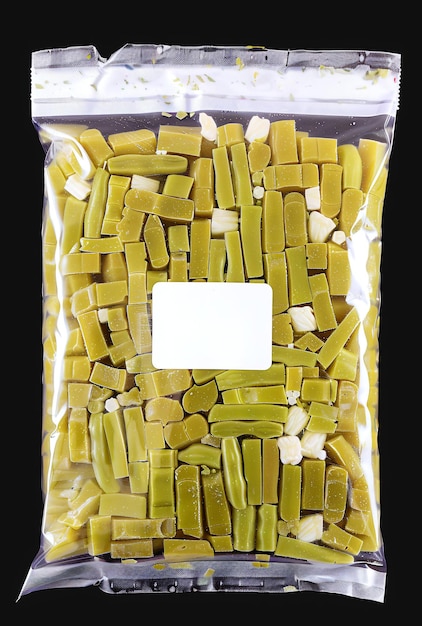 Transparent vacuumsealed plastic bag full of fresh green wax beans with a white label