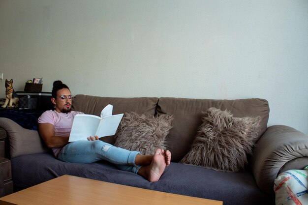 Transsexual boy reading a book at home