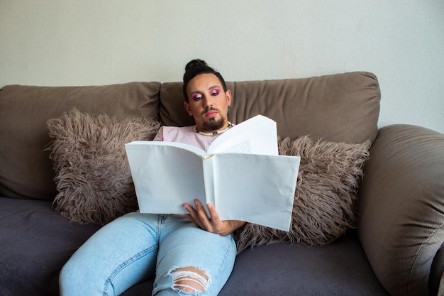 Transsexual boy reading a book at home