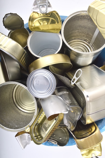 Trash can full of cans on white