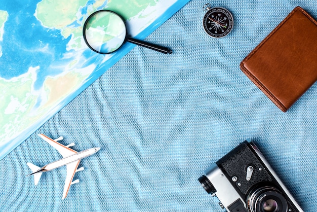 Travel accessories on blue knitted background, travel concept. Top view