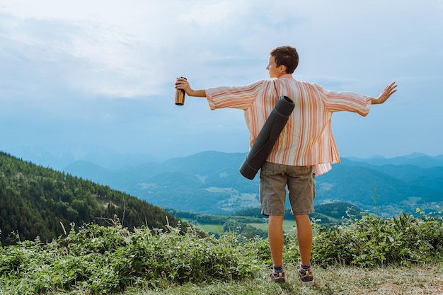 travel adventure vacation concept. Meditation alone on top of cliff, freedom, unity with nature