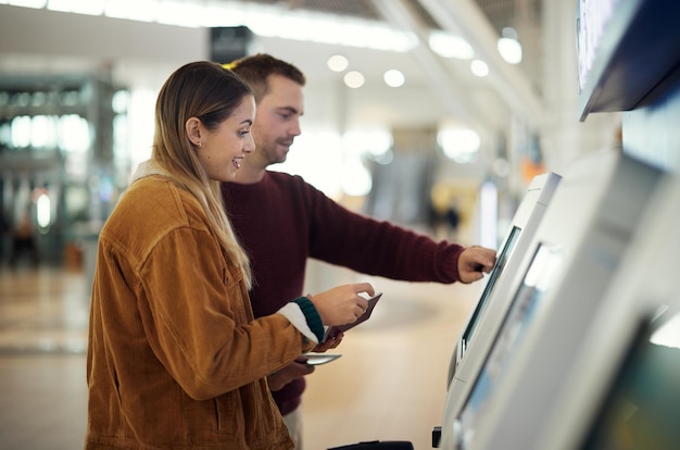 Photo travel airport and couple at check in machine with passport and ticket for flight valentines day immigration or happy man and woman by airline lobby or kiosk for boarding pass for holiday vacation