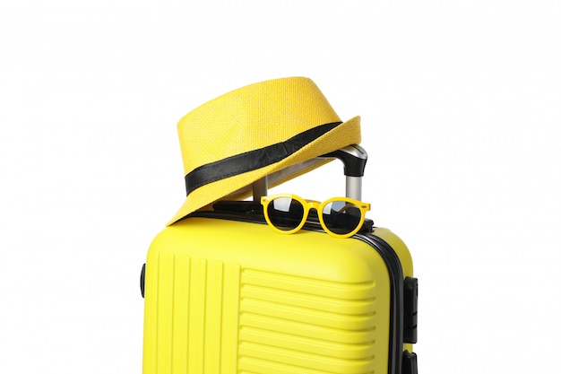 Travel bag with sunglasses and hat isolated on white