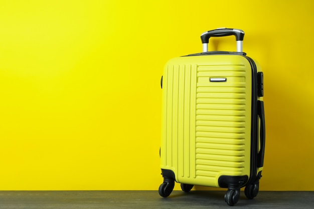 Travel bag on yellow background