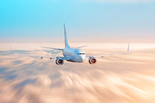 Travel by airplane flight over the clouds evening sky sunset light