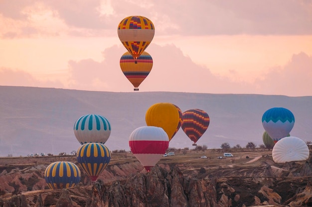 Travel in Cappadocia Colorful hot air balloons flying over the valley sunrise time with special breakfast travel destination in Turkey