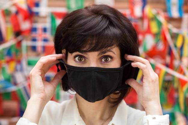 Travel company worker removes mask in connection with end of quarantine, pandemic.