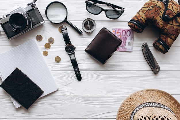 Photo travel concept,  documents, hat, compass, money, phone and camera on a white  background