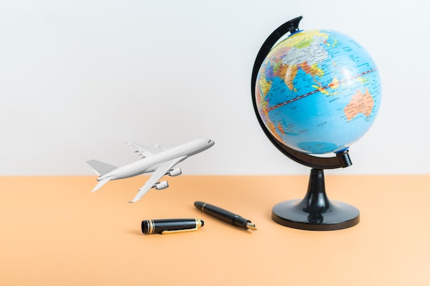 Travel concept with world map pen plane with copy space