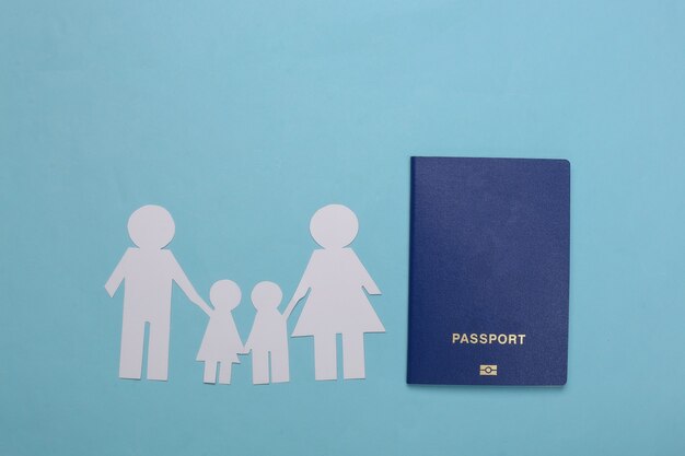 Photo travel or family immigration. paper family together and passport on a blue.