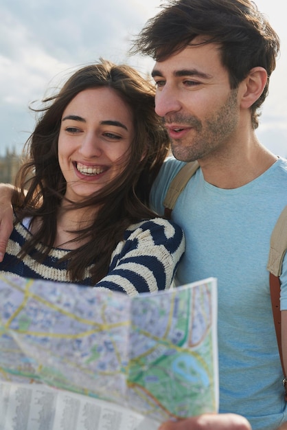 Travel map and vacation with a couple searching for directions while overseas or abroad on honeymoon Love navigation and sightseeing with a man and woman on the search for a tourist attraction