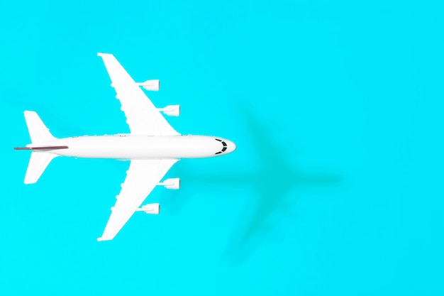 Travel minimal background. Model airplane in flight on an empty colored background. Copy space