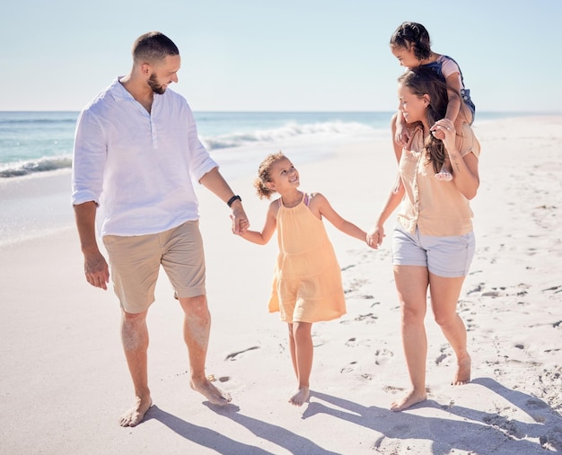 Travel relax and holding hands with family at beach together for Maldives holiday for love happy or summer Support smile or trust with parents and children walking by the sea for wellness holiday