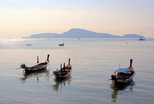 Travel to Thailand blue sea and boats on waves tropical paradise