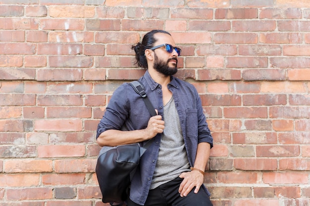 travel, tourism, lifestyle and people concept - happy smiling man with backpack standing at city street wall