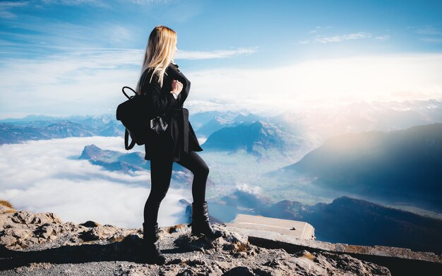 Travel tourism mountains holiday photo - Girl with backpack walking and hiking on Alps