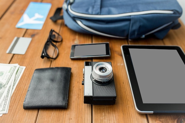 travel, tourism, technology and objects concept - close up of camera, gadgets and personal stuff