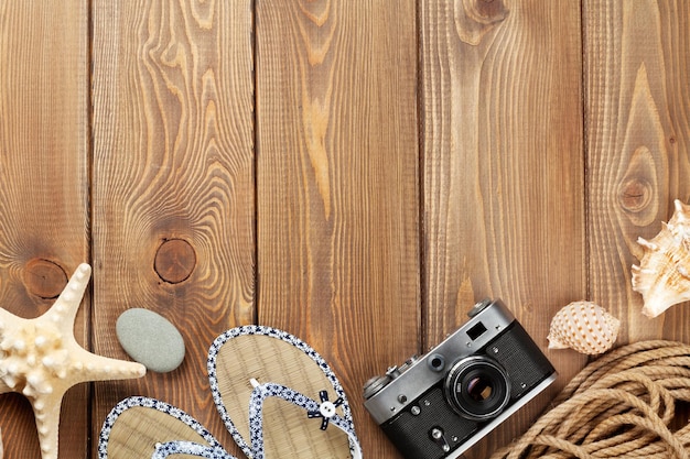 Travel and vacation items on wooden table