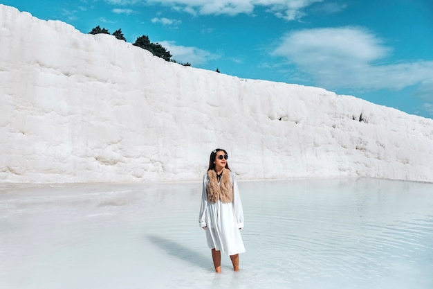 Travel woman enjoying Pamukkale tranvanter pools at ancient Hierapolis , Denizli