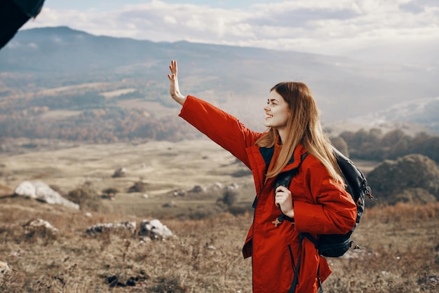 Travel woman with backpack rest in the mountains on nature landscape tourism