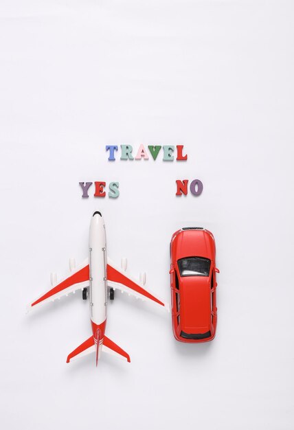 Photo travel yes or no toy car model and air plane on white background travel concept flat lay