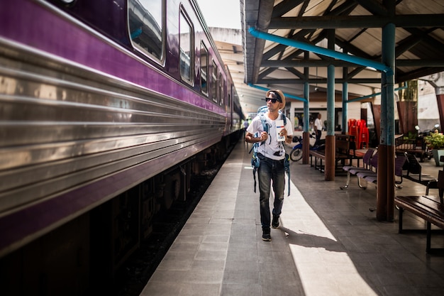 Traveler are backpacking and walking alone at train station.