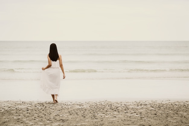 Traveler asian woman relax on beach in Thailand