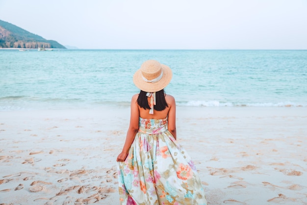 Traveler asian woman relax and travel on beach in Thailand