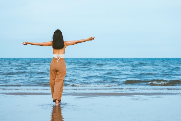 Traveler asian woman relax and travel on beach in Thailand