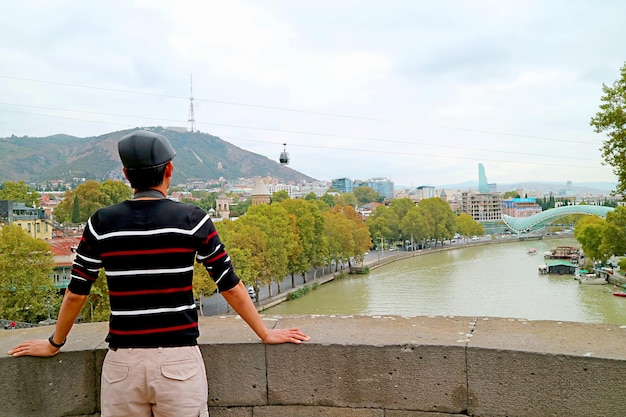 Traveler Being Impressed by Amazing Tbilisi View with Cable Car Flowing over Mtkvari River Georgia